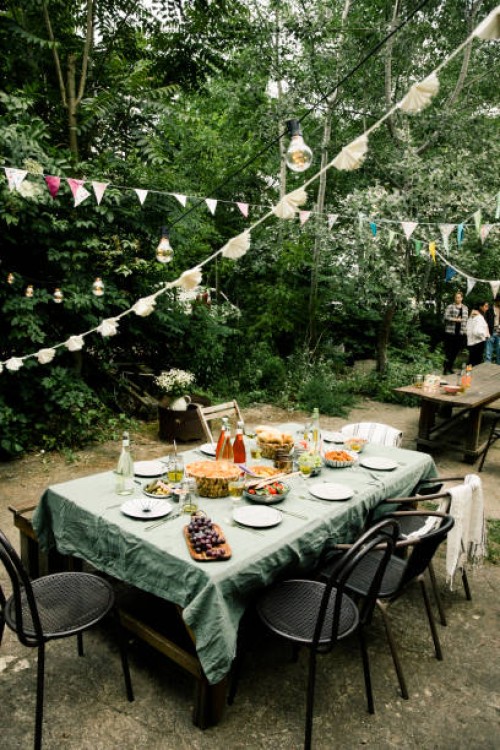 decorated back yard with food and drink set up on dining table - garden decoration stock pictures, royalty-free photos & images
