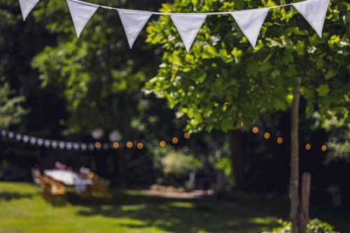 decorated garden with set table, flag garland and paper lanterns. garden party, summer festival, birthday party, baptism or wedding. - garden decoration stock pictures, royalty-free photos & images