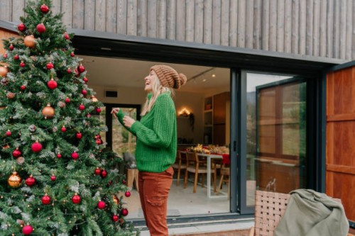 decorating my outdoor christmas tree - garden decoration stock pictures, royalty-free photos & images