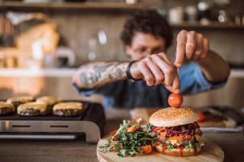 decorating tasty hamburgers - junk food stock pictures, royalty-free photos & images