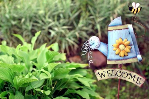 decorative garden with welcome iron signboard - garden decoration stock pictures, royalty-free photos & images
