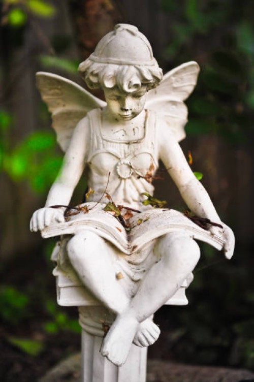 decorative statue in a home garden, fredericton, new brunswick, canada - garden decoration stock pictures, royalty-free photos & images