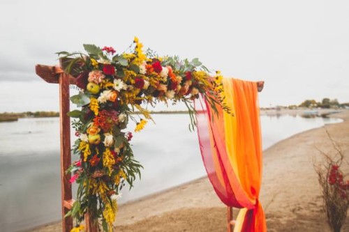 delicate bright wedding arch of flowers and fabric on the sandy shore of a river or lake. beautiful autumn decor, wedding decoration. wedding venue on the beach - home decoration stock pictures, royalty-free photos & images