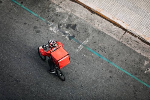 delivering food on bicycle in city - food stock pictures, royalty-free photos & images