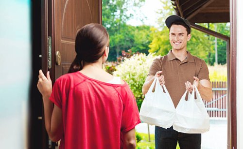 delivery man delivering chinese take away food - junk food stock pictures, royalty-free photos & images