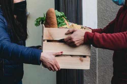 delivery man is delivering fruits, vegetables and groceries to a woman - food stock pictures, royalty-free photos & images