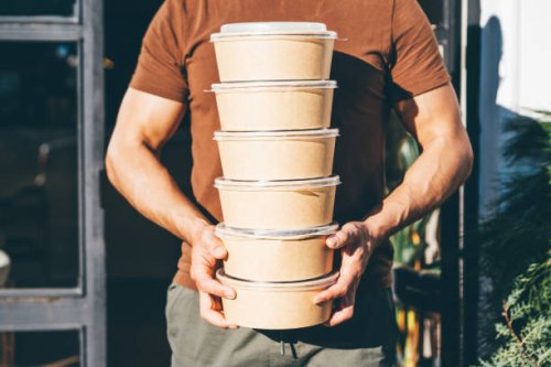 delivery man picking up take away food order. - junk food stock pictures, royalty-free photos & images