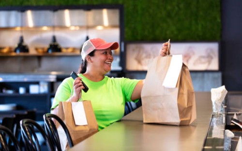 delivery person picking up restaurant takeout food order - junk food stock pictures, royalty-free photos & images