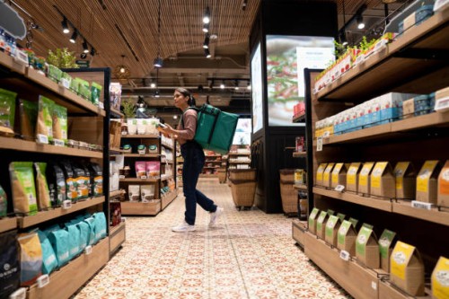 delivery person selecting products at the supermarket - junk food stock pictures, royalty-free photos & images