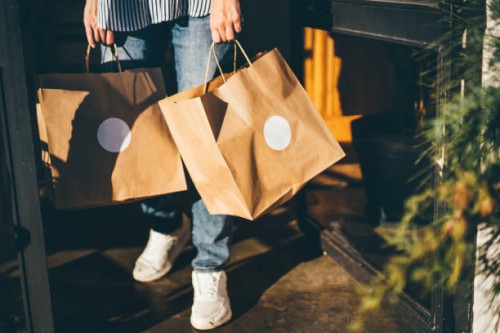 delivery woman picking up take away food order. - junk food stock pictures, royalty-free photos & images