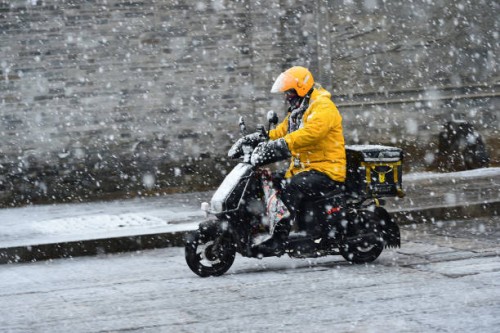 Deliveryman rides in snow on March 2, 2025 in Qingzhou, Shandong Province of China.