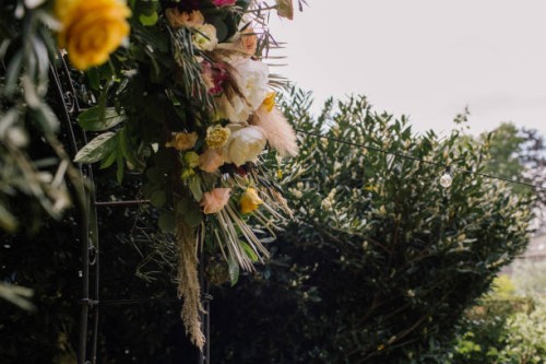 detail of a wedding arch with a large centerpiece decorated with flowers - garden decoration stock pictures, royalty-free photos & images