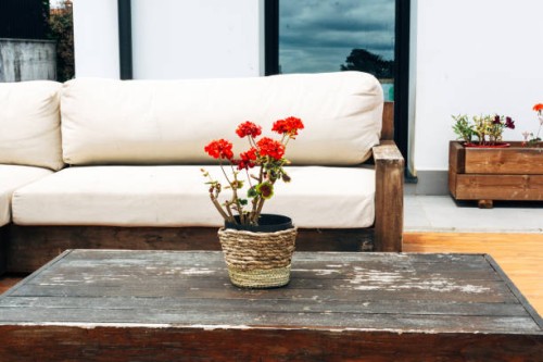 detail of an outdoor terrace of a private garden, table and wooden sofa - garden decoration stock pictures, royalty-free photos & images