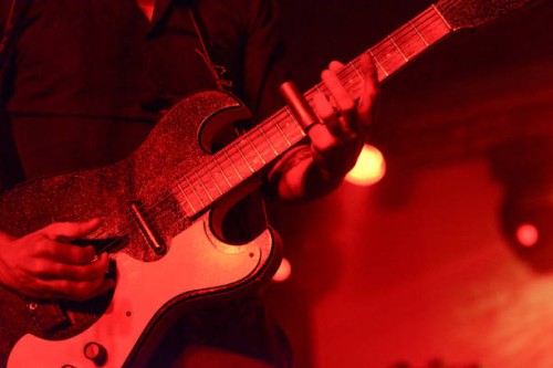 detail of man playing guitar on stage with a silde - concert stock pictures, royalty-free photos & images