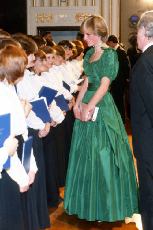 Diana, Princess of Wales, wearing an emerald green taffeta evening gown designed by Graham Wren, meets performers as she attends a gala concert at...