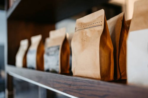 different types of coffee sorted out in paper bags in a coffee shop in kuwait - coffee stockfoto's en -beelden