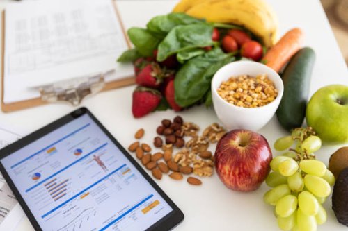 digital nutritional program with heathy food and digital tablet charts - food stock pictures, royalty-free photos & images