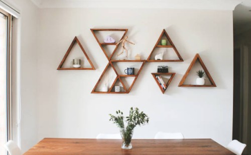 dining room area with triangle shelves as wall decor - home decoration stock pictures, royalty-free photos & images