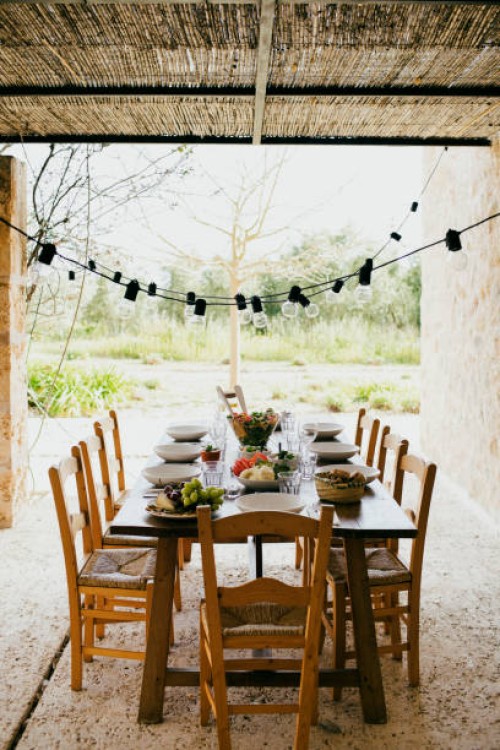 dining table with chairs and plates arranged at patio in backyard - garden decoration stock pictures, royalty-free photos & images