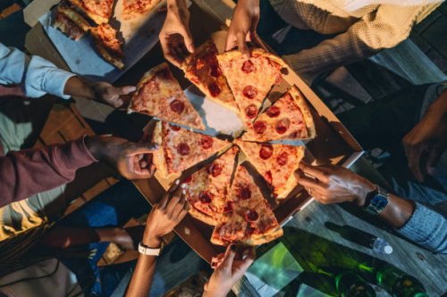 dinner party with friends - high angle view of people taking pizza slices - junk food stock pictures, royalty-free photos & images