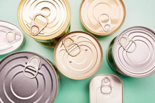 directly above shot of canned food on turquoise background - food stockfoto's en -beelden