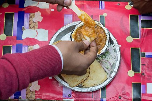 Directly Above Shot Of Man Eating Pav Bhaji.