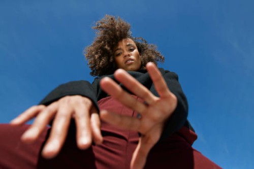 directly below portrait of woman against blue sky - fashion stock pictures, royalty-free photos & images