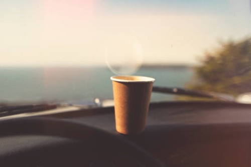 disposable paper coffee cup on dashboard - junk food stock pictures, royalty-free photos & images
