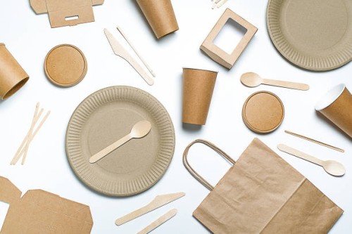disposable tableware made of bamboo wood and paper on a white background. the photo is covered in graininess and noise. - junk food stock pictures, royalty-free photos & images