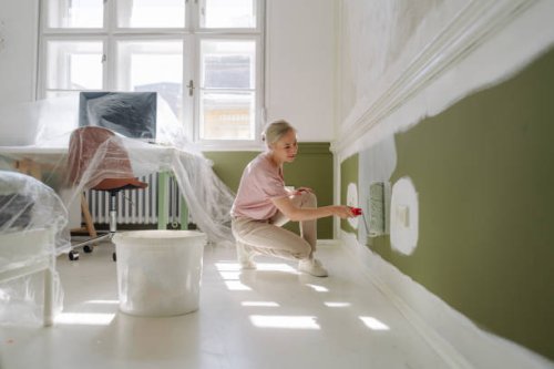 diy: a woman's painting her own apartment - home decoration stock pictures, royalty-free photos & images