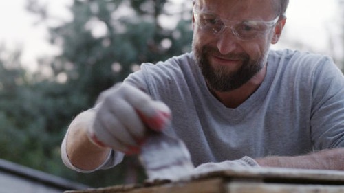 diy in the garden. man painting wooden crate - garden decoration stock pictures, royalty-free photos & images