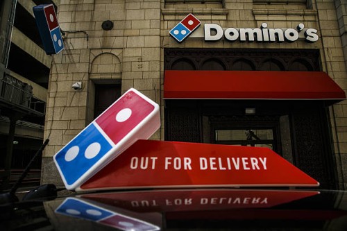Domino's Pizza Inc. Signage is displayed outside of a restaurant in Detroit, Michigan, U.S., on Wednesday, April 27, 2016. Domino's Pizza Inc. Is...