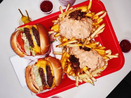 double cheeseburgers and cheese fries on a tray in fast food joint - junk food stock pictures, royalty-free photos & images