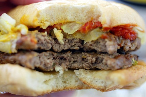 Double hamburger is seen on July 18, 2002 at a Burger King in Miami, Florida. The health effects of an American diet of super-sized fast foods are...