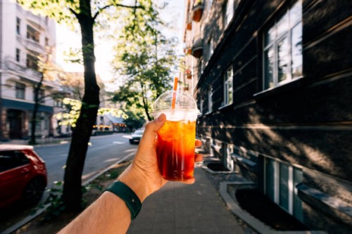 drinking iced coffee on a sunny summer day, personal perspective view - junk food stock pictures, royalty-free photos & images