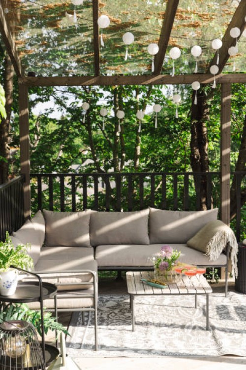 drinks on table by empty sofa at patio on sunny day - garden decoration stock pictures, royalty-free photos & images