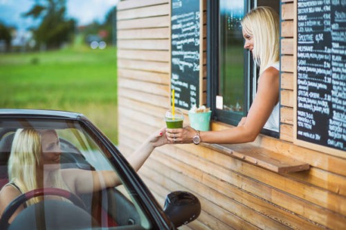 drive-in caffe female clerk with smoothie - junk food stock pictures, royalty-free photos & images