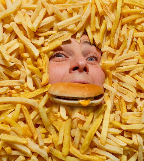 drowning in junk food - food stock pictures, royalty-free photos & images