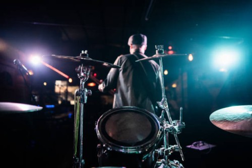 drum on stage with singer on background at nightclub - concert stock pictures, royalty-free photos & images