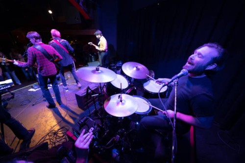 drummer singing backup vocals with band onstage - concert stock pictures, royalty-free photos & images