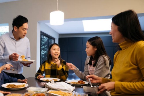 east asian parents and offspring enjoying takeout for dinner - junk food stock pictures, royalty-free photos & images