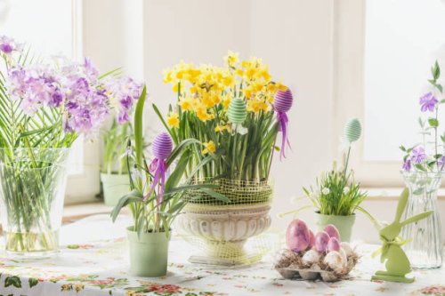 easter still life with eggs, rabbit decoration and various springtime flowers in pots and vases - garden decoration stock pictures, royalty-free photos & images