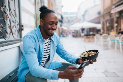 eating a take out food outdoors - junk food stock pictures, royalty-free photos & images