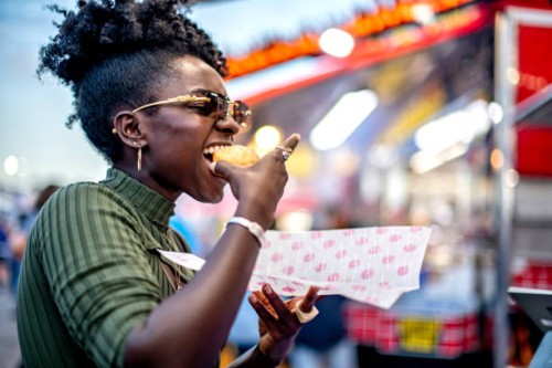 eating at the fair - food stockfoto's en -beelden