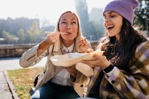 eating chinese food on the street - junk food stock pictures, royalty-free photos & images