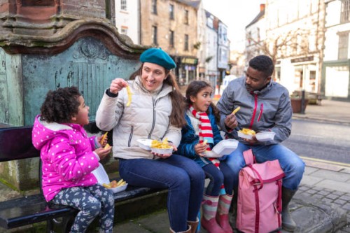 eating chips in the town centre - junk food stock pictures, royalty-free photos & images
