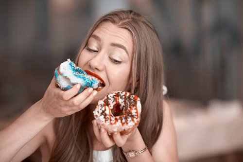 eating delicious donuts - junk food stock pictures, royalty-free photos & images