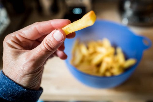 eating french fries - junk food stock pictures, royalty-free photos & images