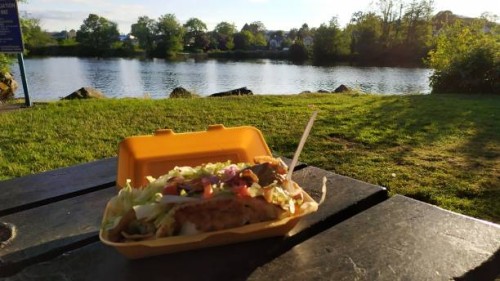 eating kebab ( take out food) close to a lake on a sunny day - junk food stock pictures, royalty-free photos & images