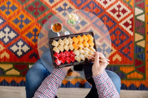 eating sushi at home, directly above personal perspective view - junk food stock pictures, royalty-free photos & images